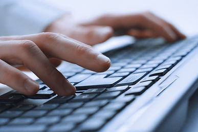 Hands at a computer keyboard